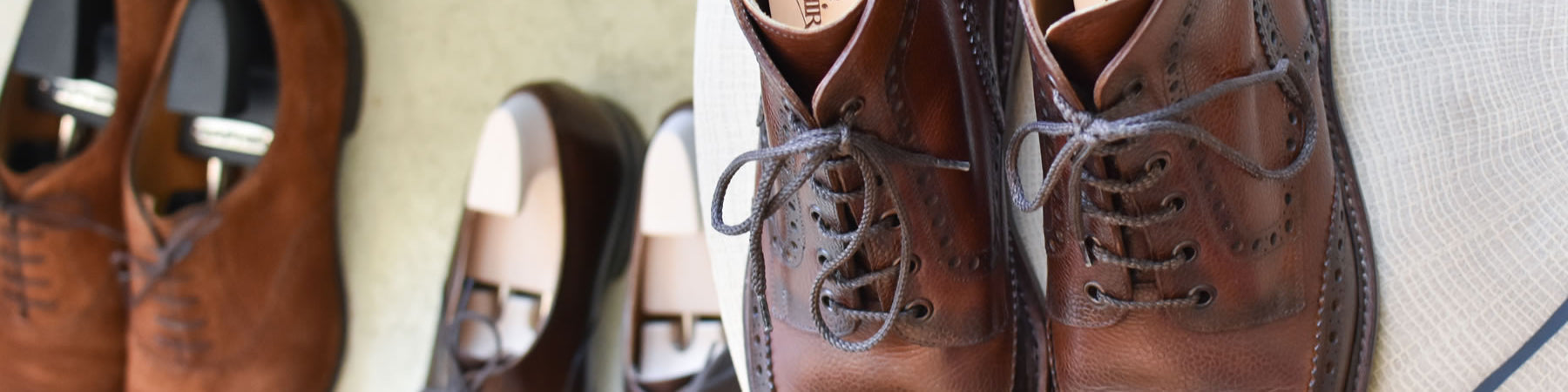 Well-cared-for brown leather shoes and shoe trees, a testament to preserving footwear, evoking a sense of timeless style.
